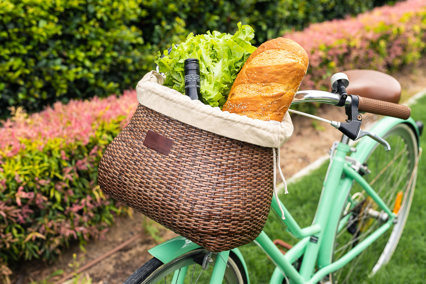 Bike Basket Front installed on a gren bike holding bread, wine and salad